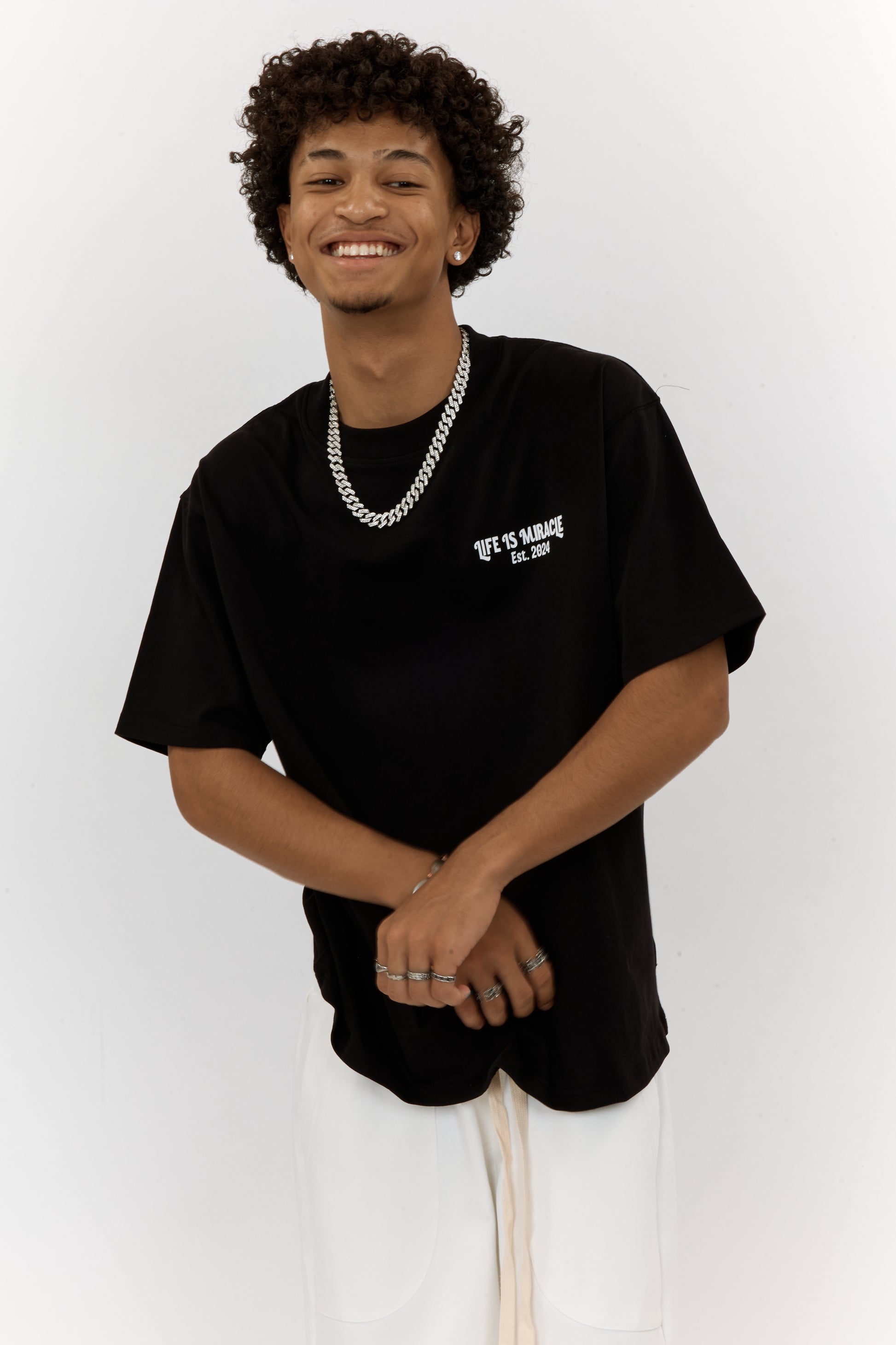 Person wearing a black t-shirt with text on a white background