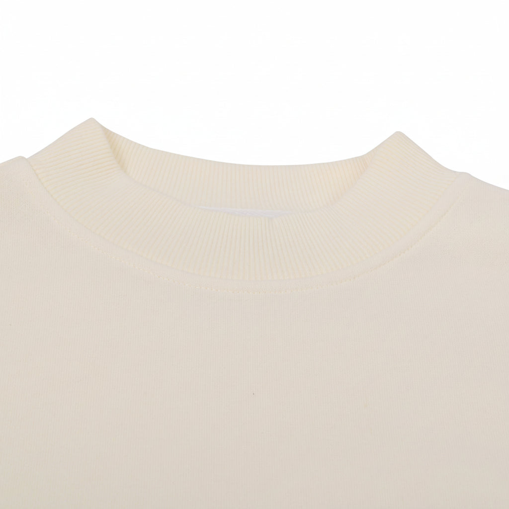 Close-up of a beige sweater with a collar on a white background