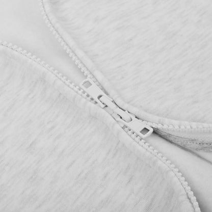 Close-up of a zipper on a light gray fabric background