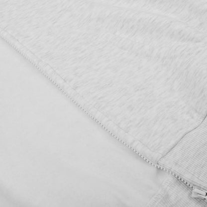 Close-up of a textured white fabric with a zipper