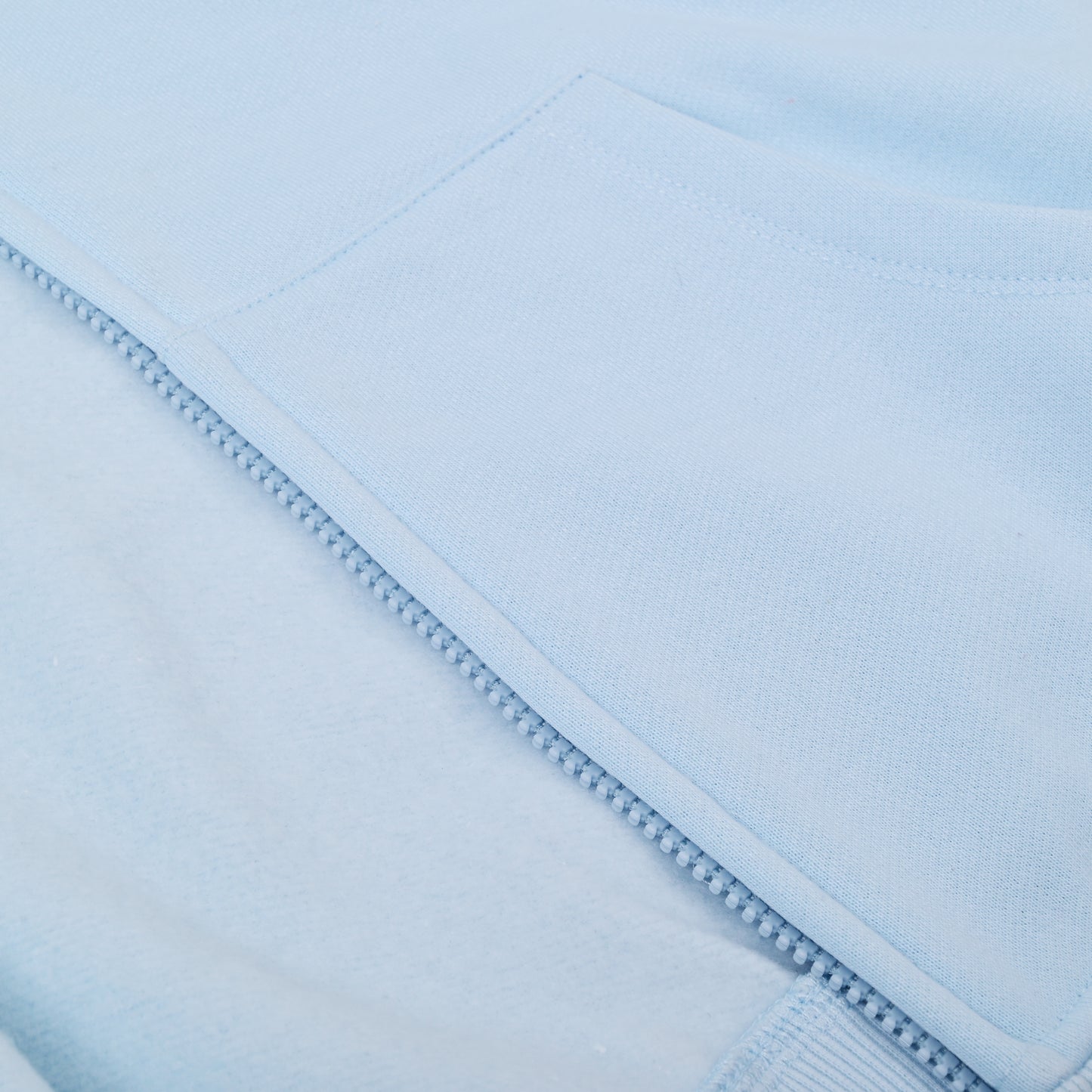 Close-up of a light blue fabric with a subtle pattern