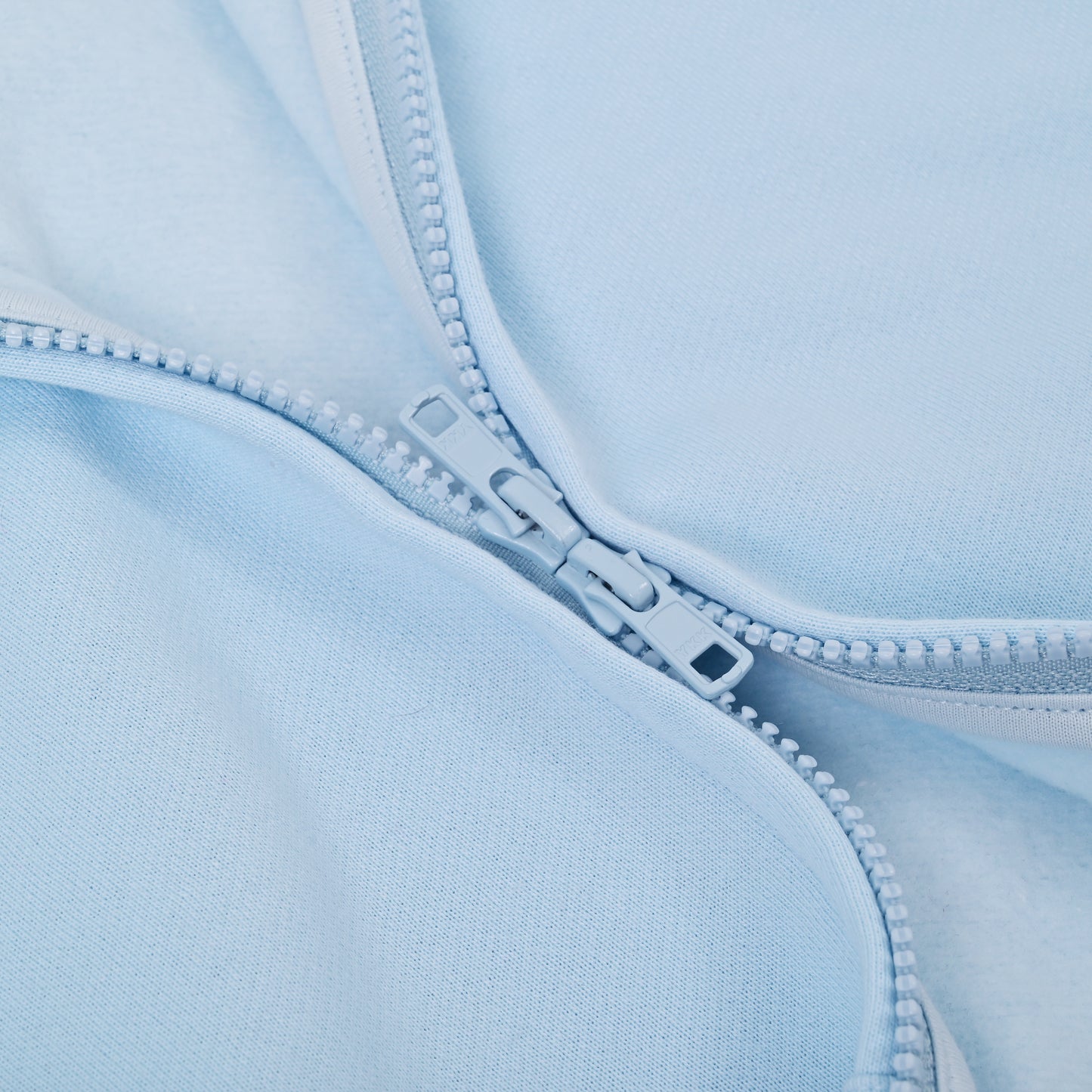 Close-up of a light blue fabric with a zipper