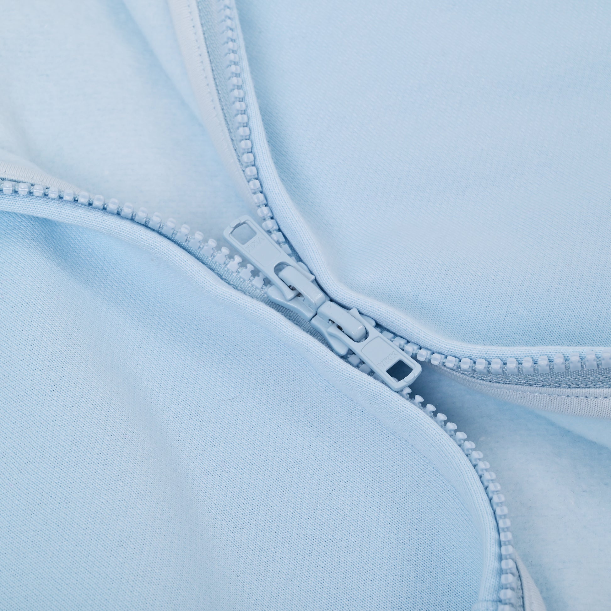 Close-up of a light blue fabric with a zipper