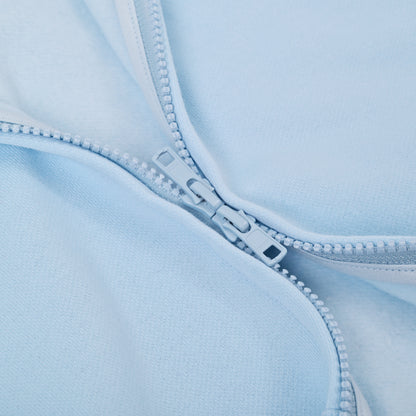 Close-up of a light blue fabric with a zipper